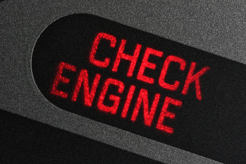 A dashboard check engine light flashes red.