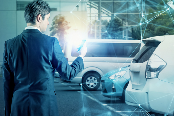 A business traveler locates his rental car using his phone.