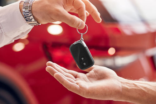 A customer returning a key fob to a rental operator.