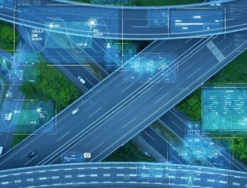 Aerial view of a highway with computer telematics graphics overlaid.