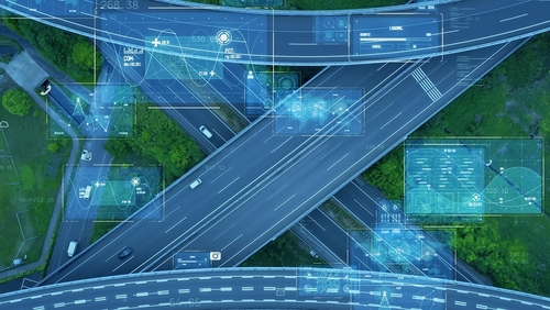 Aerial view of a highway with computer telematics graphics overlaid.