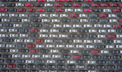 aerial view of lines of cars in a vehicle lot