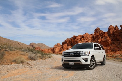 white ford expedition facing camera on a desert road