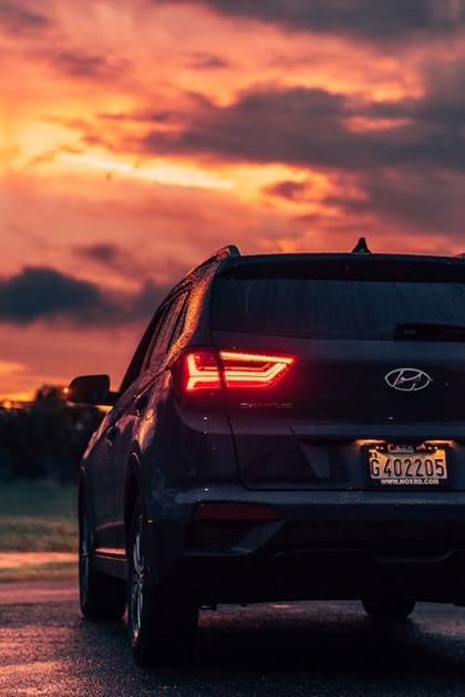 back end of hatchback with brake lights on at dusk