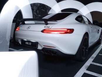 back end of a white Mercedes coupe with spoiler and taillights on