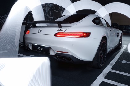 back end of a white Mercedes coupe with spoiler and taillights on